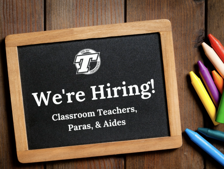 Chalkboard with chalk with text saying "We're hiring Clasroom Teachers, Paras, & Aides