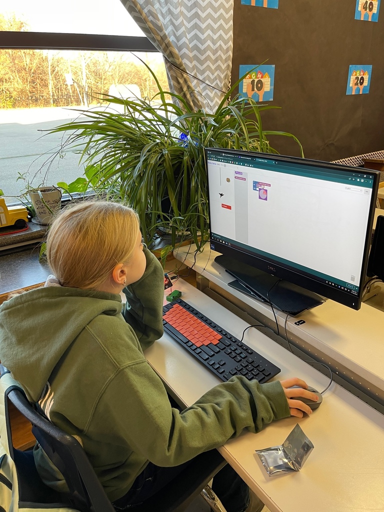 A middle school student codes on a computer.