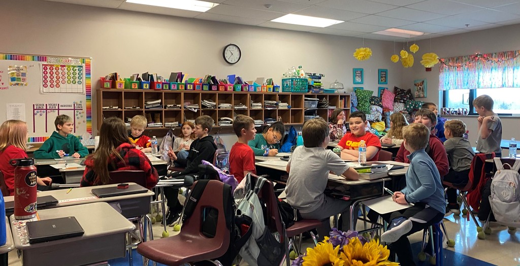 fourth grade students sit at their desks in a classroom