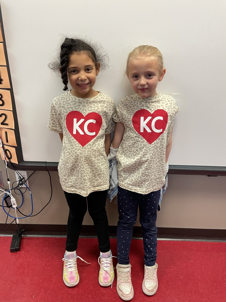 two kindergarteners wearing cheetah print tees with red KC hearts on them