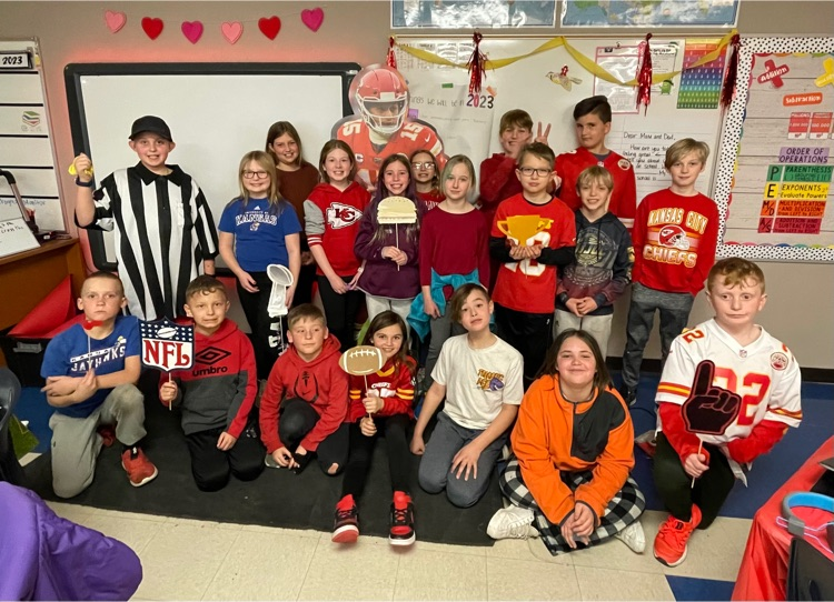 Miss Cornwell’s 4th graders pose holding football themed props