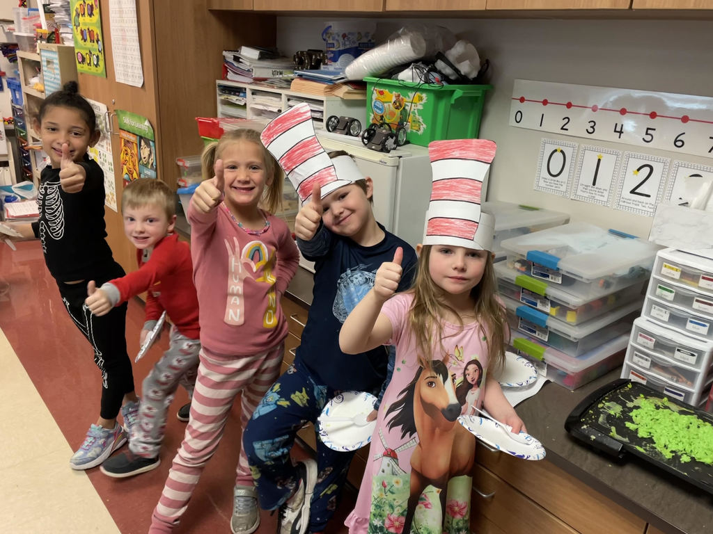 five students give a thumbs up for reading