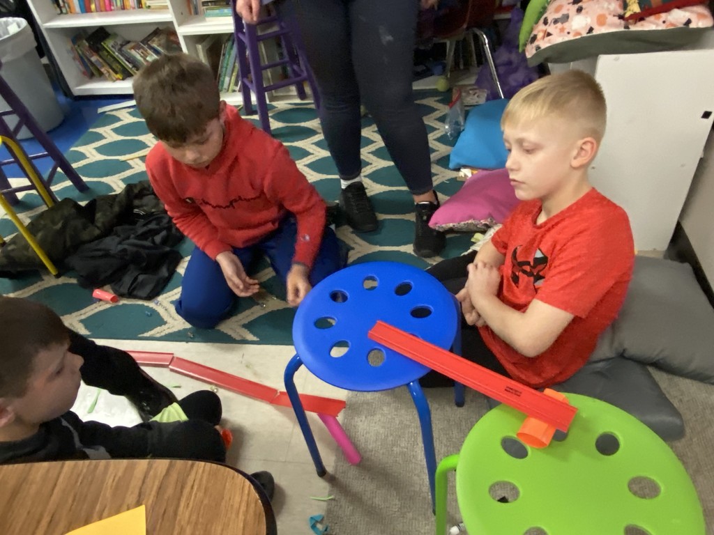 students use stools and chutes to demonstrate energy