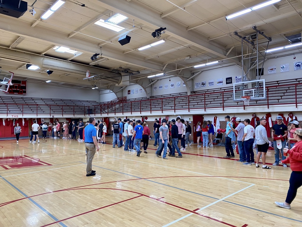 students line up in the auxiliary gym