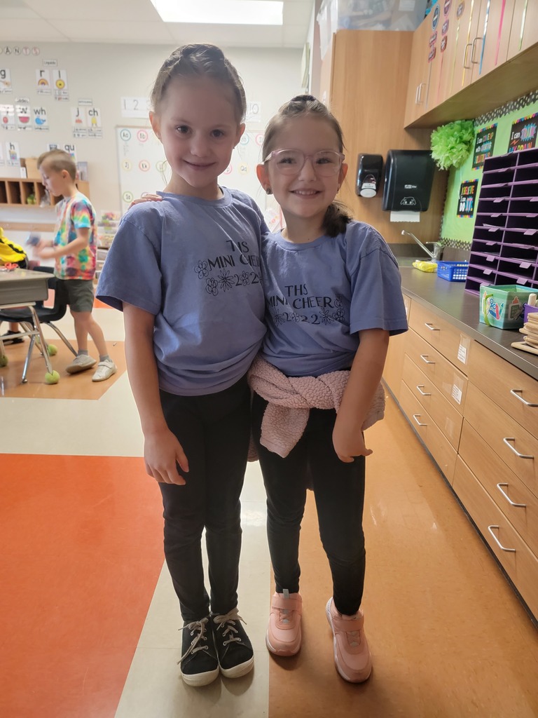 two students wearing TMS mini cheer camp t shirts