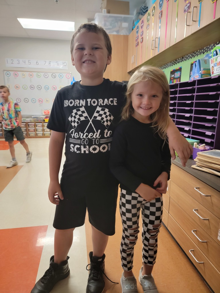 two students wearing black and white checkered race clothes