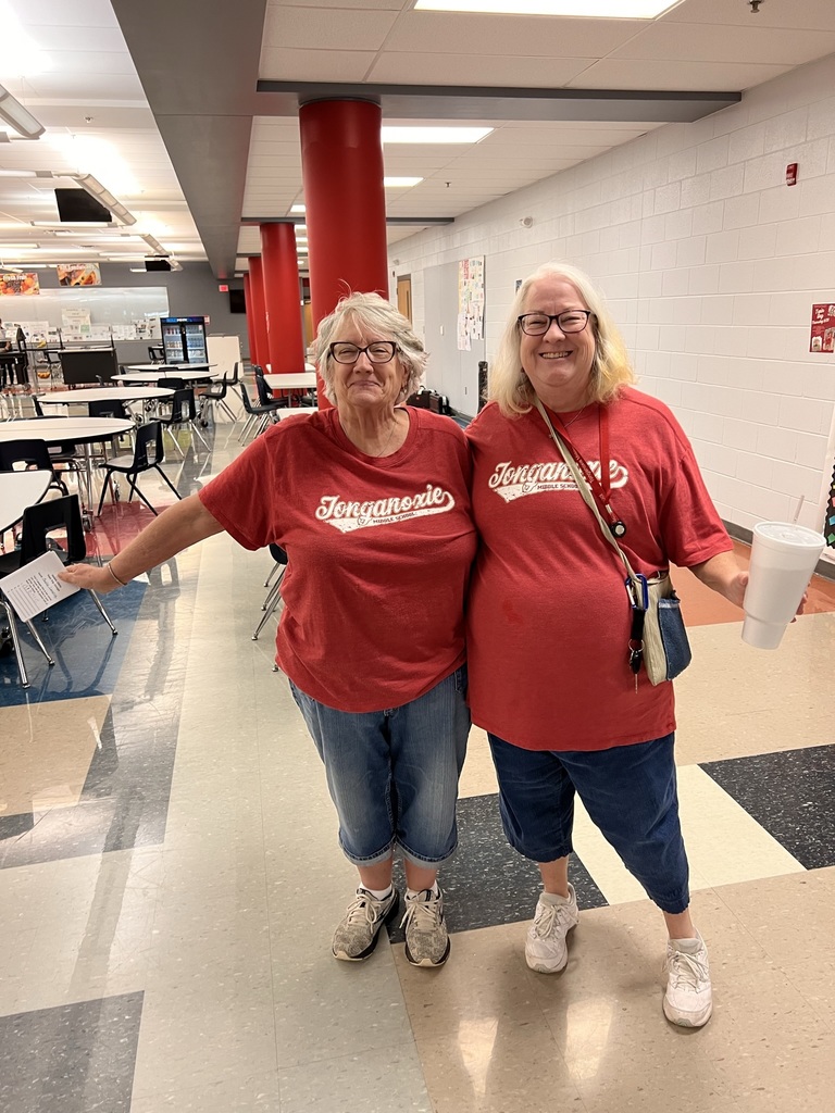 two employees wearing red Tonganoxie shirts