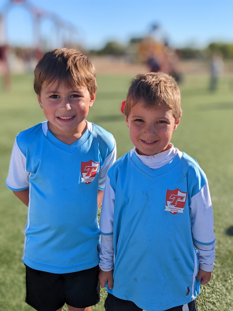 two students wearing blue soccer jerseys