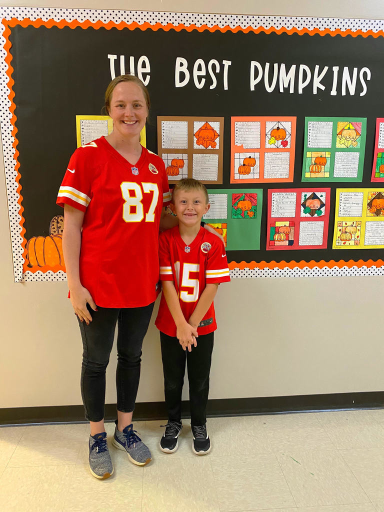 teacher and student wearing Chiefs jerseys