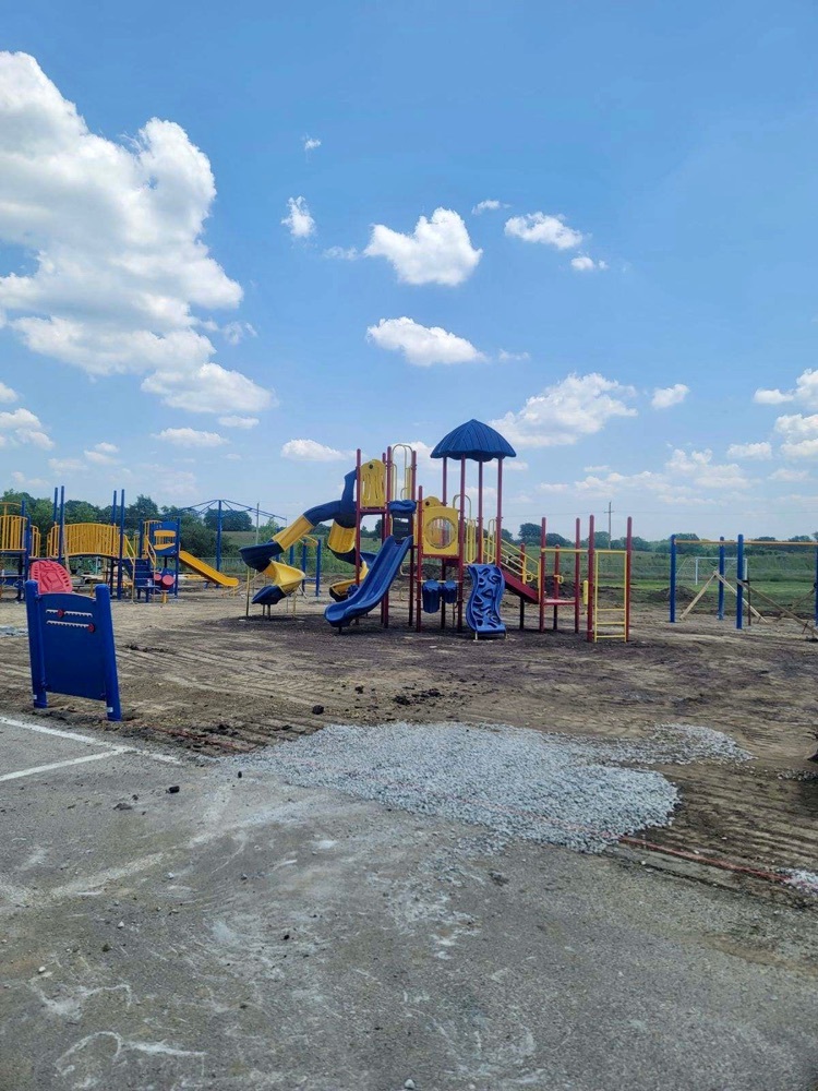 playground structure on dirt and gravel surface 